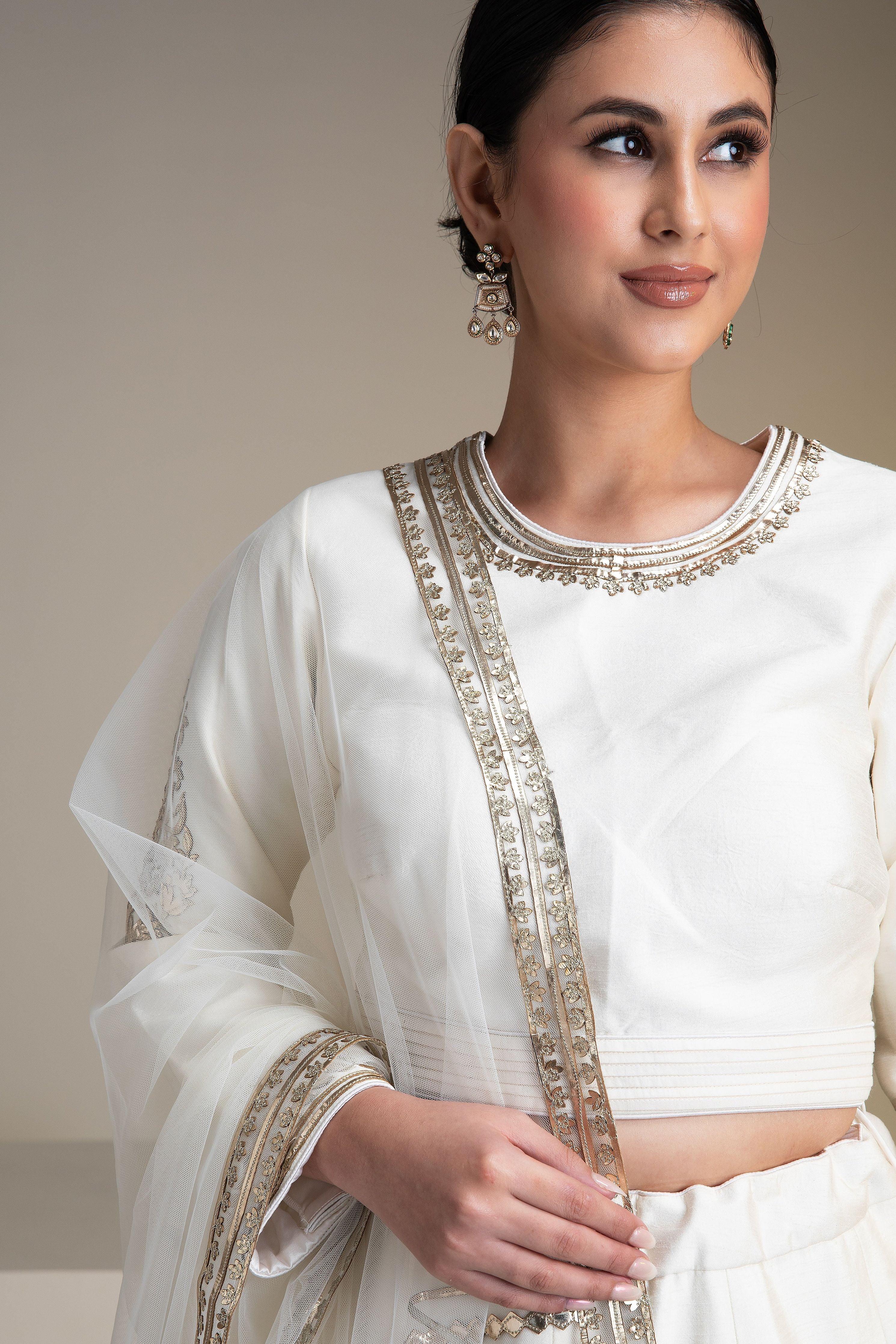 Pristine White Silk Lehenga Set With Metallic Gold Embroidery - Mokshaa