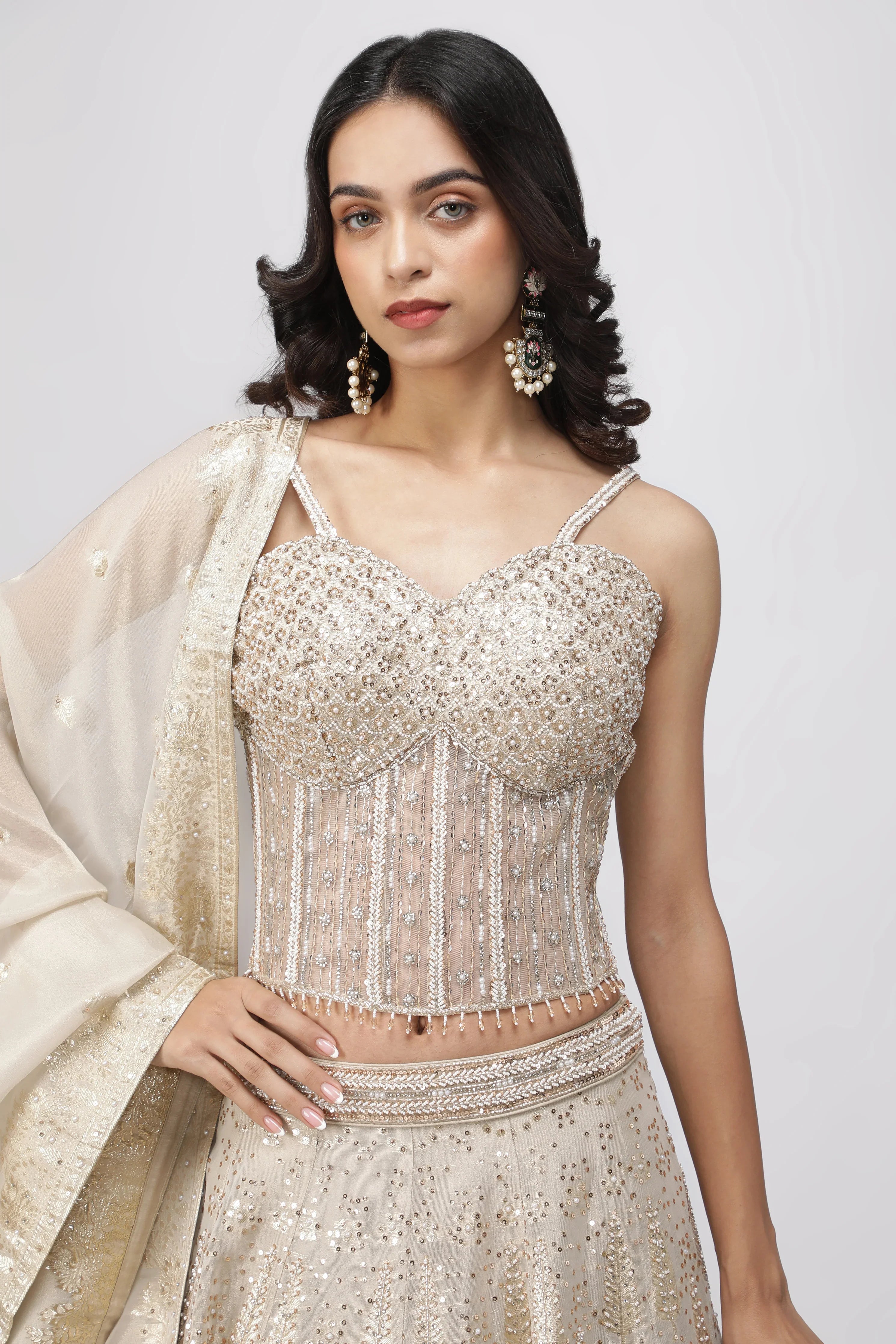 Ivory Banarasi Tissue Lehenga with Pearl Embellished Corset Blouse - Mokshaa