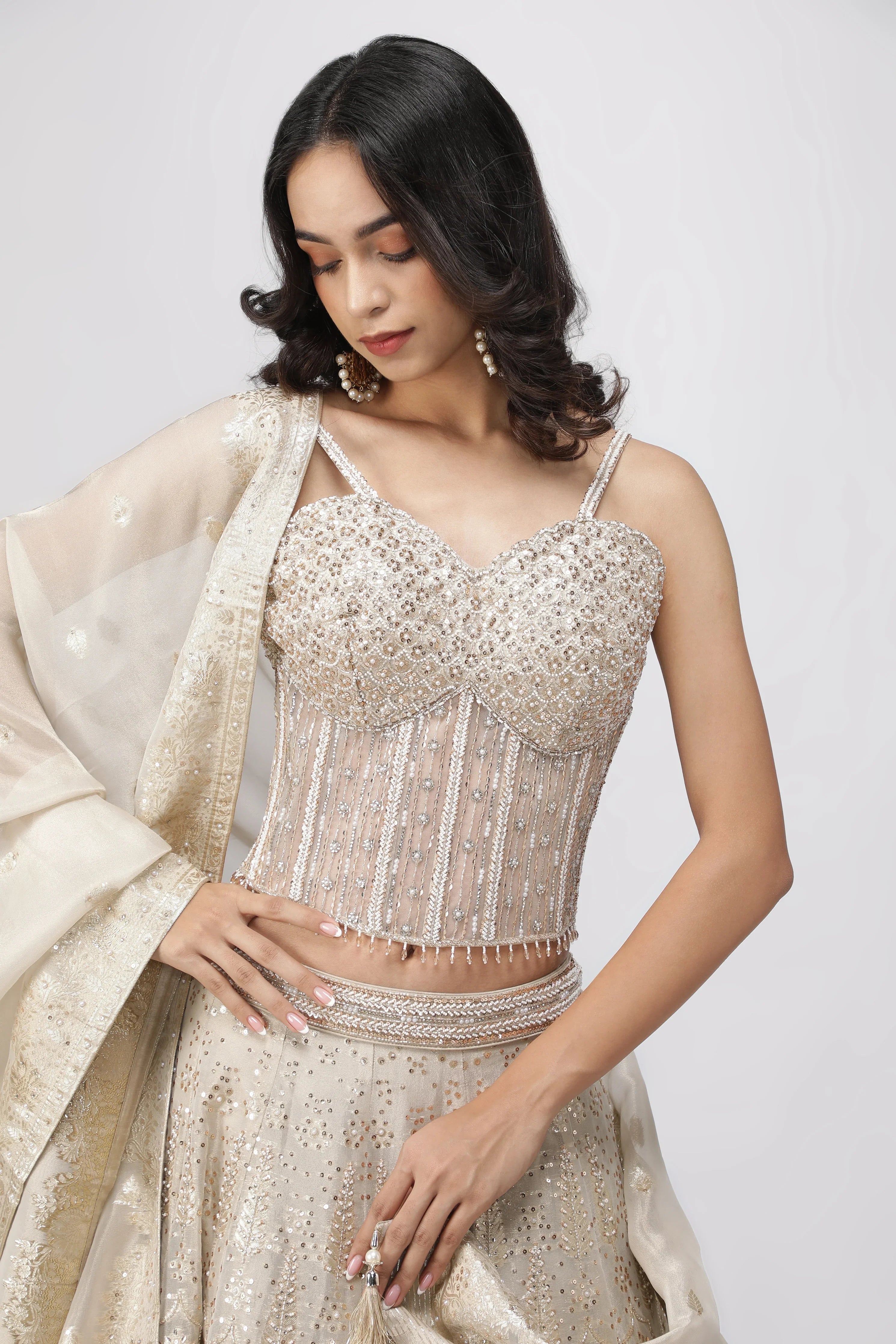 Ivory Banarasi Tissue Lehenga with Pearl Embellished Corset Blouse - Mokshaa