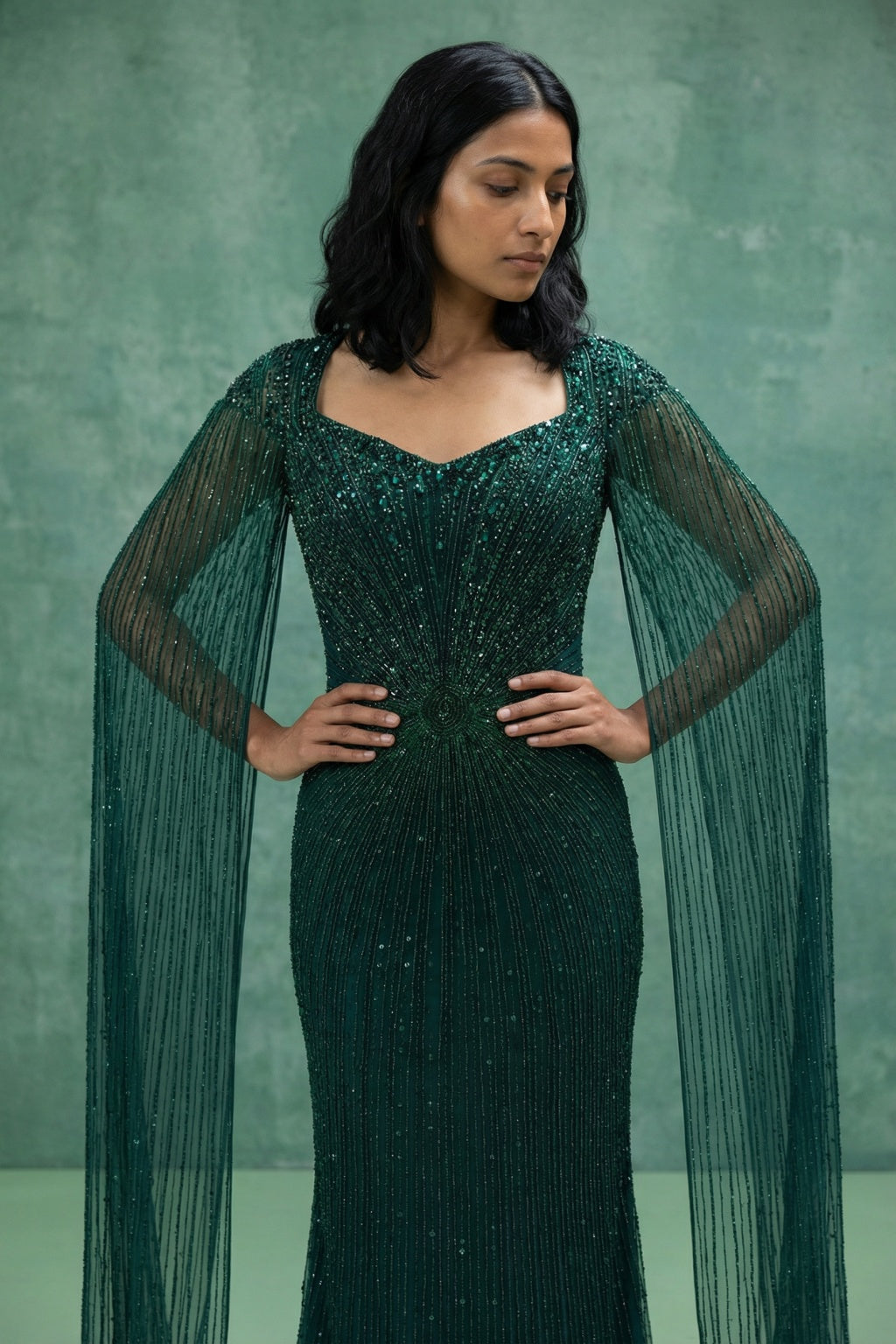 Bottle Green Net Mermaid Gown with Cape Sleeves - Mokshaa