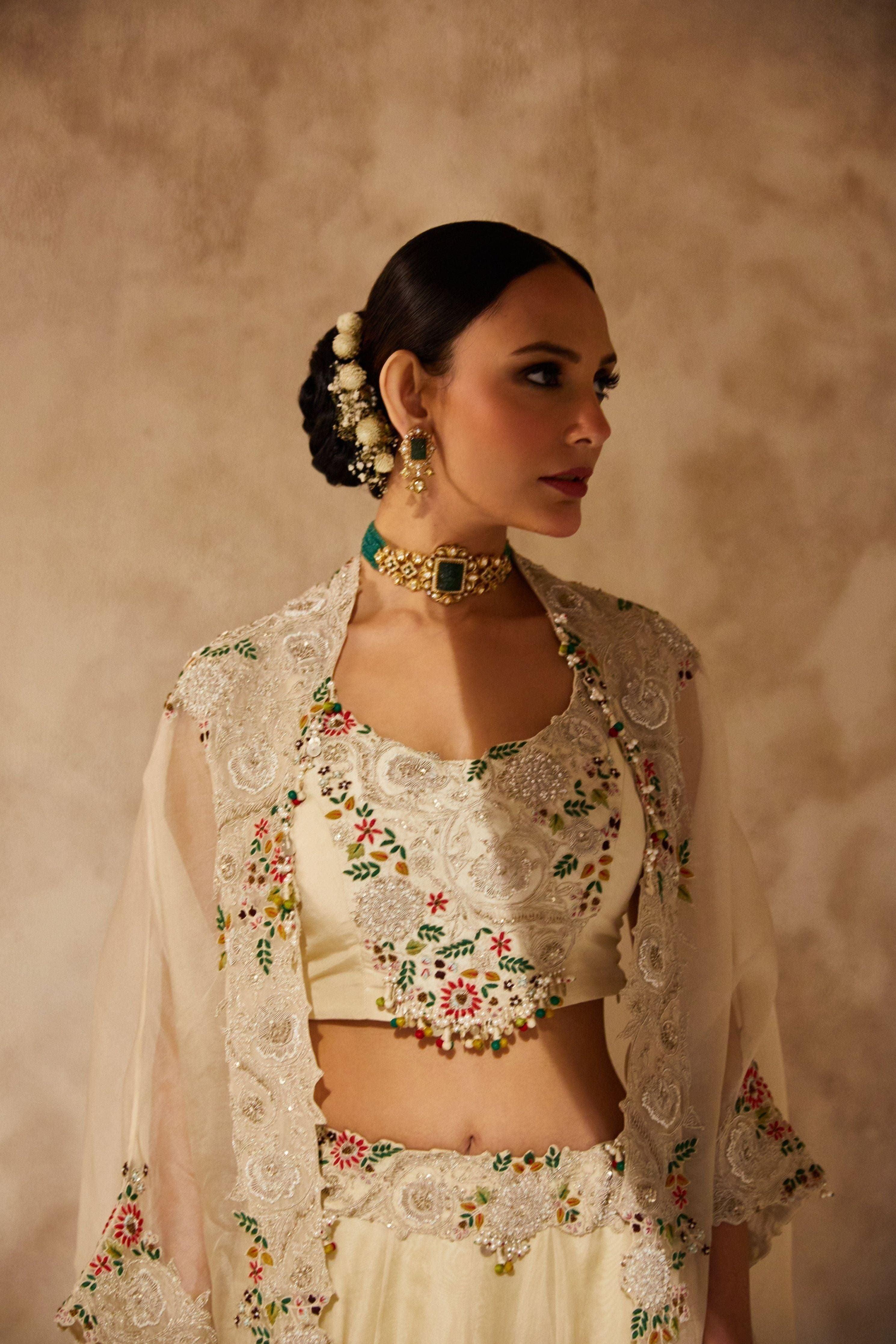Ivory Silk Blouse With Organza Cape And Lehenga - Mokshaa