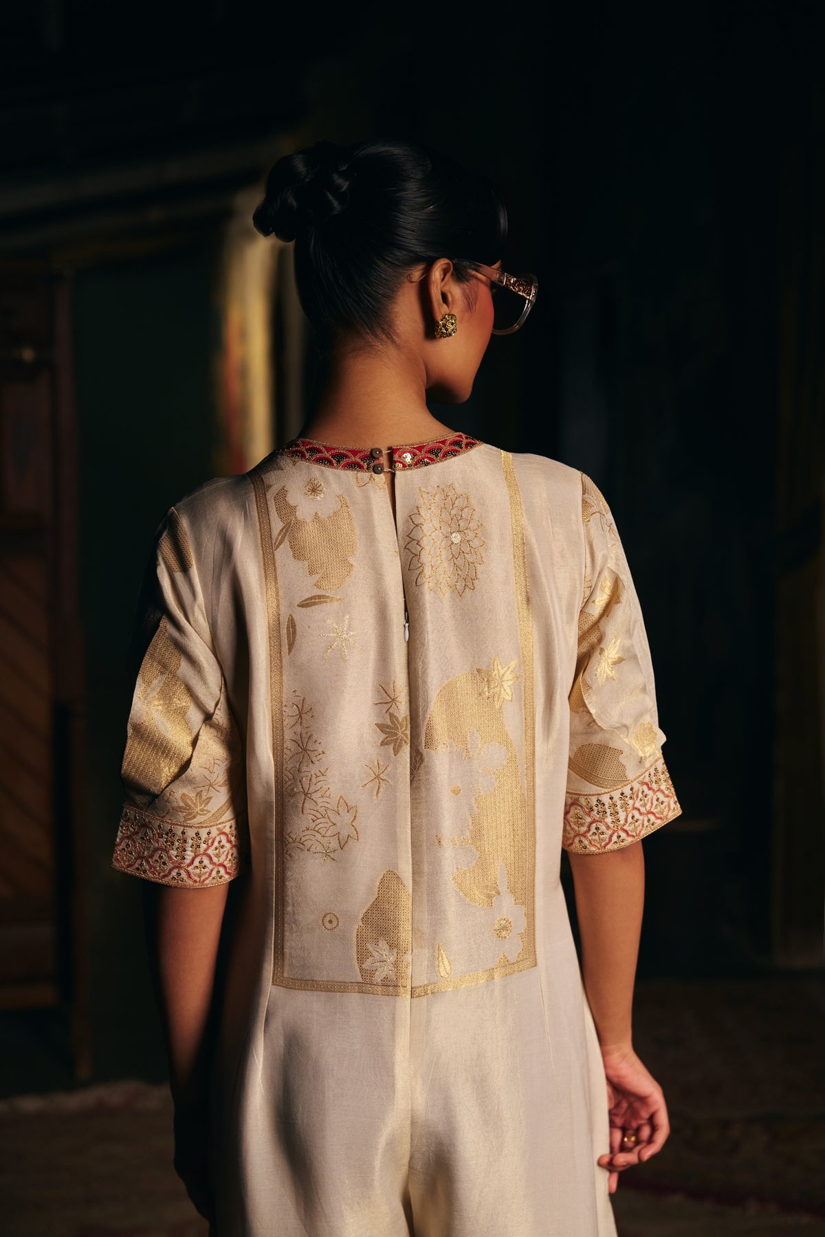 Ivory Banarasi Tissue Jumpsuit with Gold Woven Motifs and Embroidered Neckline - Mokshaa