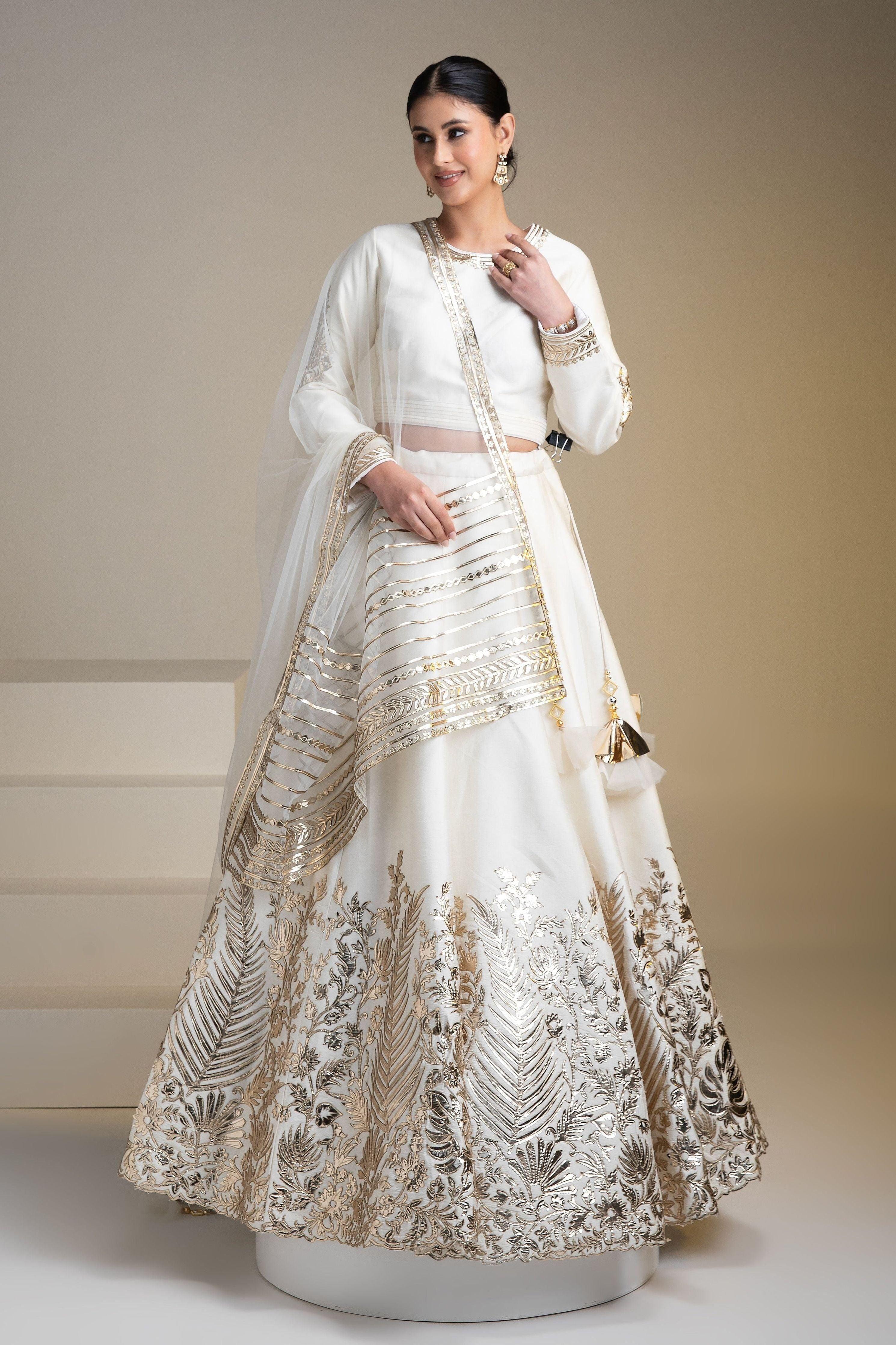 Pristine White Silk Lehenga Set With Metallic Gold Embroidery - Mokshaa