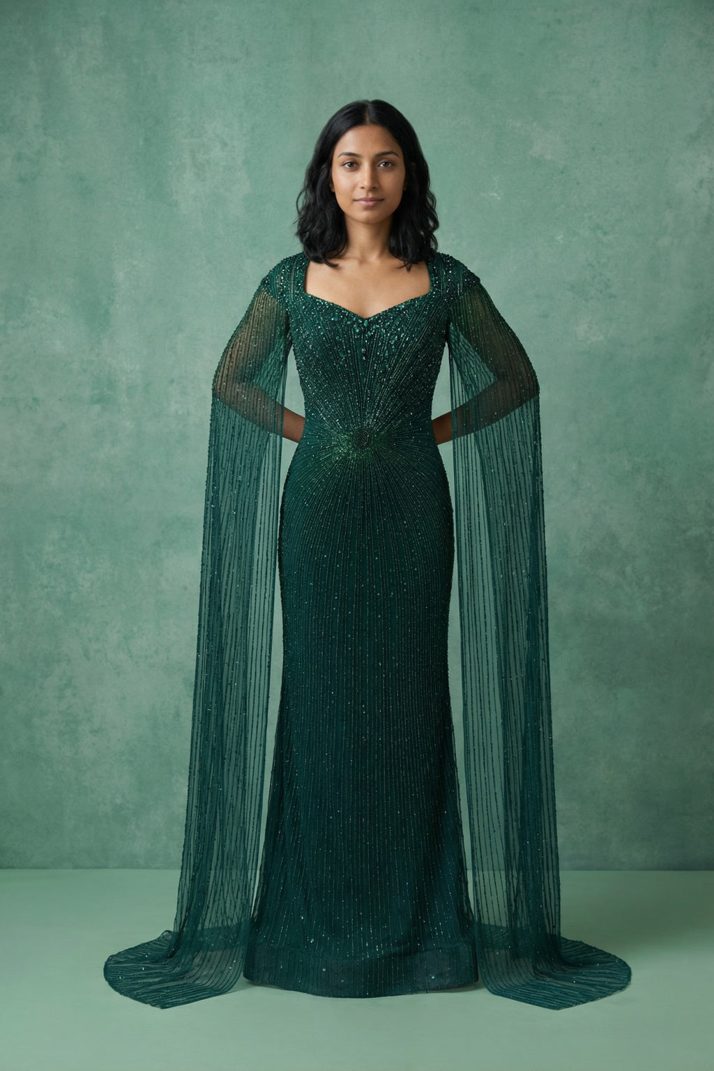 Bottle Green Net Mermaid Gown with Cape Sleeves - Mokshaa