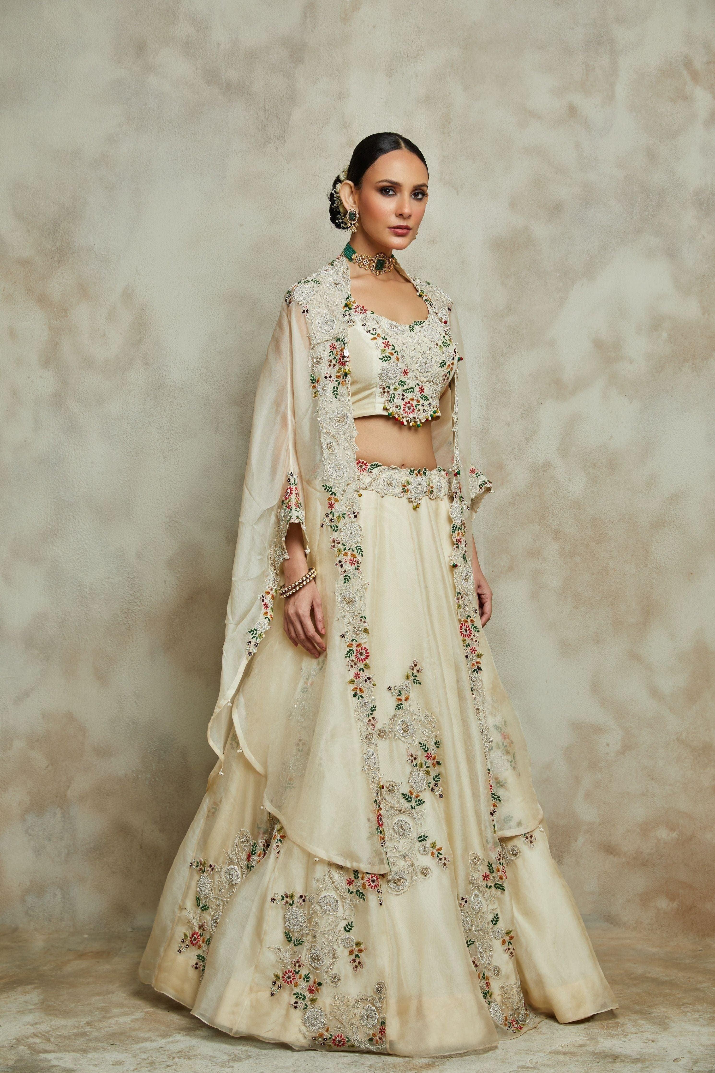Ivory Silk Blouse With Organza Cape And Lehenga - Mokshaa